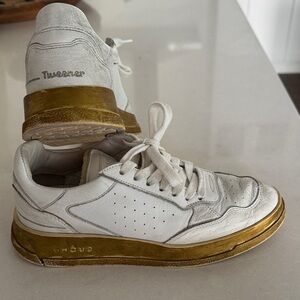 GHOUD tweeter low top sneaker. Distressed white leather with gold bottom
